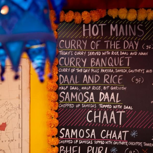 The menu board at Snackwallah in Grianger Market offering a range of curries